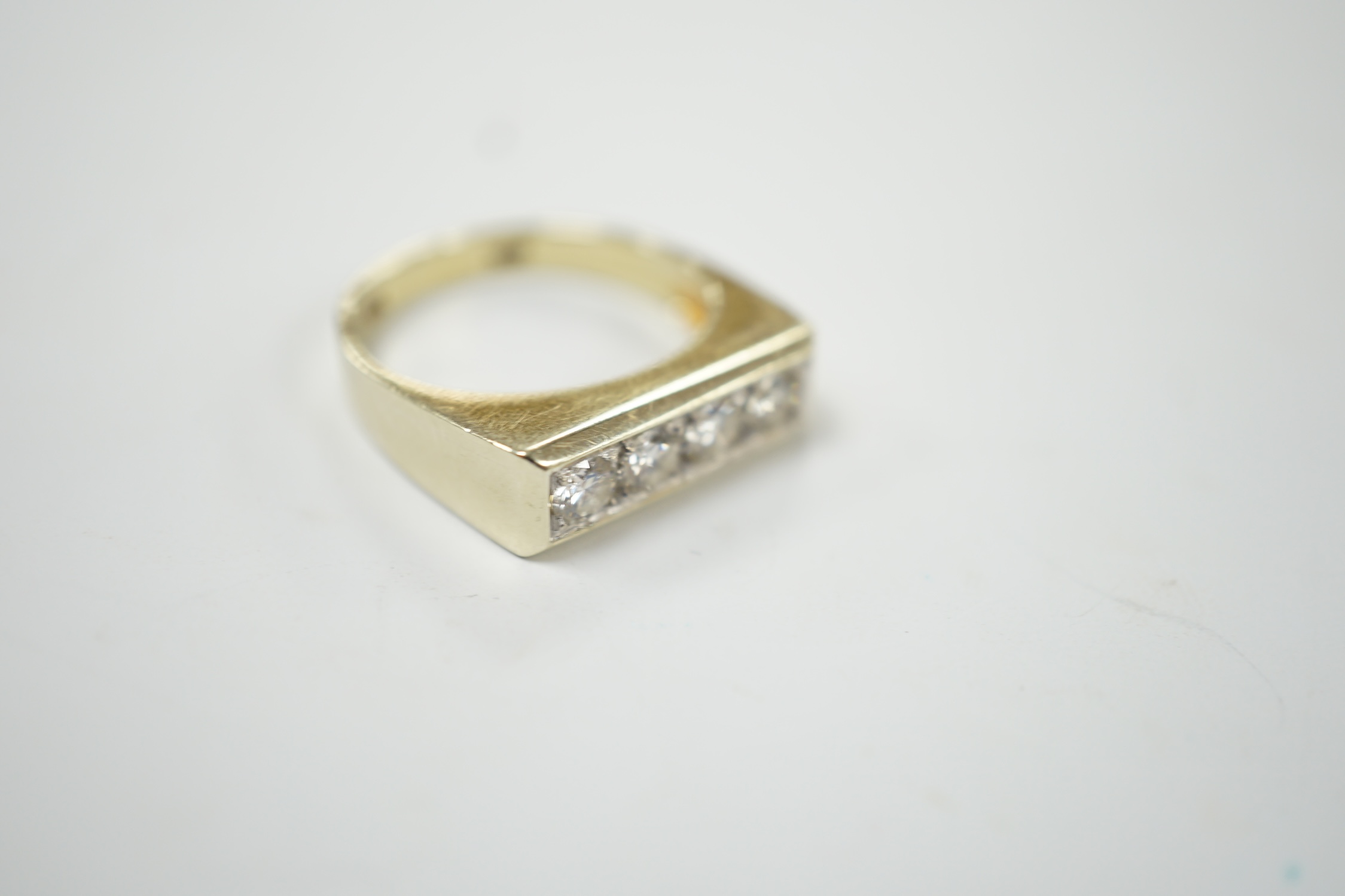 A 585 yellow metal and channel set four stone diamond ring, size P, gross weight 6.2 grams. Good condition.